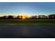 Stunning landscape view with vibrant greenery and a breathtaking sunset over the horizon at 15373 Evans Ranch Rd, Lakeland, FL 33809