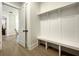 Hallway with built-in mudroom bench, coat hooks, and a view into the adjacent dining room at 15373 Evans Ranch Rd, Lakeland, FL 33809