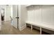 Bright mudroom with built-in bench seating, storage, and tiled floors for a stylish and functional entryway at 15373 Evans Ranch Rd, Lakeland, FL 33809