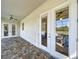 Covered patio with tile floor, ceiling fans, and view of the screened pool at 15373 Evans Ranch Rd, Lakeland, FL 33809