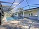 Screened in swimming pool with paver patio, a built-in bar and a well maintained backyard at 15373 Evans Ranch Rd, Lakeland, FL 33809