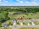 Aerial view of home backing to wooded preserve; two-car garage; manicured lawns; sunny sky at 1936 Bell Creek Loop, Fruitland Park, FL 34731