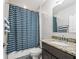 Bathroom featuring a shower with blue wave curtain, granite countertops, and neutral color scheme at 1936 Bell Creek Loop, Fruitland Park, FL 34731