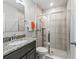 Updated bathroom with granite countertop, framed mirror, and a glass-enclosed tiled shower at 1936 Bell Creek Loop, Fruitland Park, FL 34731