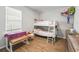 Bedroom with wood-look floors, a window letting in natural light, and a playful setup at 1936 Bell Creek Loop, Fruitland Park, FL 34731