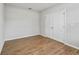 Bright bedroom featuring wood floors and a double-door closet at 1936 Bell Creek Loop, Fruitland Park, FL 34731