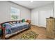 Bedroom with wood-look floors, natural light, and double closets for ample storage at 1936 Bell Creek Loop, Fruitland Park, FL 34731