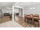 Open-concept dining room with wood floors, chandelier, and views of living spaces at 1936 Bell Creek Loop, Fruitland Park, FL 34731