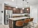 Modern kitchen featuring granite countertops, stainless steel appliances, and a center island at 1936 Bell Creek Loop, Fruitland Park, FL 34731