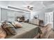 Bright main bedroom with a tray ceiling, ceiling fan, and plenty of natural light at 1936 Bell Creek Loop, Fruitland Park, FL 34731