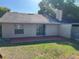 A cozy backyard with a red patio, sliding door access, and an idyllic spot for outdoor relaxation at 2408 Fabry Cir, Orlando, FL 32817