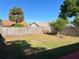 Backyard featuring a wooden fence, well-kept grass, and partial shade, creating a private outdoor space at 2408 Fabry Cir, Orlando, FL 32817