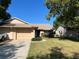 Charming single story home with a well-maintained lawn, a two car garage and mature trees in a residential neighborhood at 2408 Fabry Cir, Orlando, FL 32817
