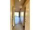 Bright foyer featuring tile flooring, leading into a living area with appealing hardwood floors and a sliding glass door at 2408 Fabry Cir, Orlando, FL 32817