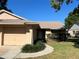 Inviting single story home with a well-manicured lawn, and a two car garage on a sunny day at 2408 Fabry Cir, Orlando, FL 32817