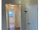 Hallway view shows a bathroom with natural light, as well as ample closet storage at 2408 Fabry Cir, Orlando, FL 32817