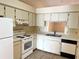 Efficient kitchen with white appliances, tile flooring, and ample counter space, creating a practical cooking environment at 2408 Fabry Cir, Orlando, FL 32817