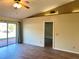 Cozy living room with ceiling fan, hardwood floors, sliding glass doors and an adjacent entryway for easy living at 2408 Fabry Cir, Orlando, FL 32817