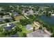 Aerial view of neighborhood with lush lawns, mature trees, and a tranquil lake nearby at 2561 Rogers Rd, Lakeland, FL 33812