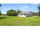 View of a large, well-maintained backyard with lush green grass and a single story home at 2561 Rogers Rd, Lakeland, FL 33812