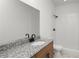 This bathroom includes a granite vanity, a shower-tub combo, and bronze hardware at 2561 Rogers Rd, Lakeland, FL 33812