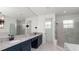 Lavish bathroom with granite counters, dual sinks, and a seamless glass shower at 2561 Rogers Rd, Lakeland, FL 33812