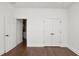 This bedroom features wood floors, a closet, and an en-suite bath at 2561 Rogers Rd, Lakeland, FL 33812