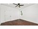 This bedroom features dark wood floors, a ceiling fan, and one window at 2561 Rogers Rd, Lakeland, FL 33812