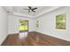 Bright bedroom boasts tray ceilings, ceiling fan, and sliding glass doors to the backyard at 2561 Rogers Rd, Lakeland, FL 33812