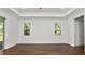Light-filled bedroom with hardwood floors and dual windows for ample natural light at 2561 Rogers Rd, Lakeland, FL 33812