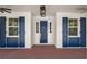 Elegant entryway showcasing a stylish door with sidelights, decorative shutters, and brick flooring at 2561 Rogers Rd, Lakeland, FL 33812