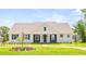 Charming home featuring a quaint covered entryway, fresh green lawn and beautiful exterior accents at 2561 Rogers Rd, Lakeland, FL 33812