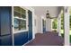 Inviting porch with brick flooring, decorative columns, stylish lighting and shutter accents at 2561 Rogers Rd, Lakeland, FL 33812