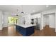 Open kitchen featuring a large island with granite counters, stainless appliances and ample natural light at 2561 Rogers Rd, Lakeland, FL 33812