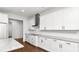 Bright kitchen featuring white cabinets, granite countertops and stainless steel range hood at 2561 Rogers Rd, Lakeland, FL 33812
