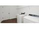 This laundry room features white washer and dryer appliances and wire shelving at 2561 Rogers Rd, Lakeland, FL 33812