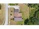 Birds-eye view of the house displaying the roof, driveway, lawn, landscaping, and neighboring properties at 34 Misty Meadow Ln, Mulberry, FL 33860