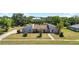An aerial view of a beautiful home with a large, well-maintained lawn at 34 Misty Meadow Ln, Mulberry, FL 33860