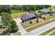 An aerial view showcases the home's unique architecture, driveway, landscaping, and surrounding neighborhood at 34 Misty Meadow Ln, Mulberry, FL 33860