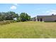 Expansive backyard featuring a lush lawn and mature trees, perfect for outdoor activities and relaxation at 34 Misty Meadow Ln, Mulberry, FL 33860