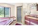 A bathroom with a jacuzzi tub, shower, and a vanity with a countertop and sink at 34 Misty Meadow Ln, Mulberry, FL 33860