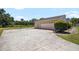 Long driveway leading up to a house with a two car garage at 34 Misty Meadow Ln, Mulberry, FL 33860