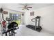 Bright exercise room with large windows and a variety of workout equipment at 34 Misty Meadow Ln, Mulberry, FL 33860
