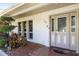 Inviting front entrance with decorative door, sidelights and attractive landscaping at 34 Misty Meadow Ln, Mulberry, FL 33860