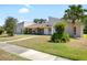 A charming one-story home with a well-manicured lawn and mature landscaping at 34 Misty Meadow Ln, Mulberry, FL 33860