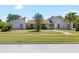 Charming one-story home with well-manicured lawn and mature landscaping at 34 Misty Meadow Ln, Mulberry, FL 33860