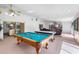 Entertaining game room features a pool table, air hockey, a ceiling fan, and views of the backyard at 34 Misty Meadow Ln, Mulberry, FL 33860