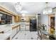Bright kitchen featuring white appliances, wood cabinets, and decorative tile floors at 34 Misty Meadow Ln, Mulberry, FL 33860