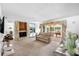 Spacious living room featuring a stone fireplace, plush carpeting, and sliding glass doors leading to outdoor area at 34 Misty Meadow Ln, Mulberry, FL 33860