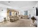 Bright living room with a plush carpeting, stylish furniture, and large windows that offer ample natural light at 34 Misty Meadow Ln, Mulberry, FL 33860